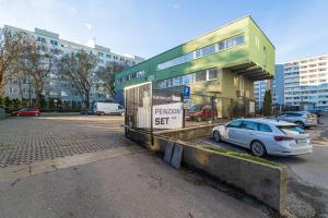 a car parked in a parking lot in front of a building at Penzion Set in Košice