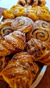 a bunch of pastries on a plate on a table at Hotel Halászkert Badacsony in Badacsonytomaj