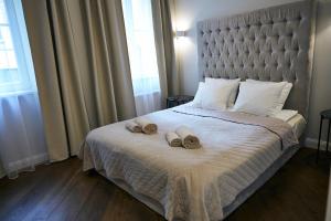 a bedroom with a bed with two slippers on it at COZY apartment in the City Center in Vilnius