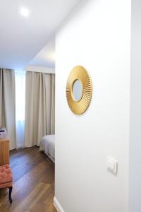 a room with a bed and a mirror on the wall at COZY apartment in the City Center in Vilnius