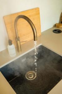 a sink with water coming out of a faucet at Resort de Weelderik in Hengelo