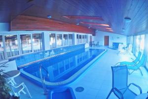 a large swimming pool in a large building at Hotel Halászkert Badacsony in Badacsonytomaj
