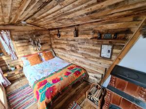 a bedroom with a bed in a wooden cabin at Fisherman's Cabin (Friendship Land) in Şelari