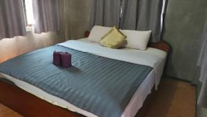 a bed with two pillows on top of it at Charlie's House in Pai +12 photos