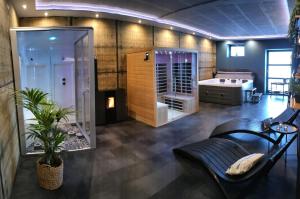 a bathroom with a shower and a bath room at La folie 20 Spa in Hon-Hergies