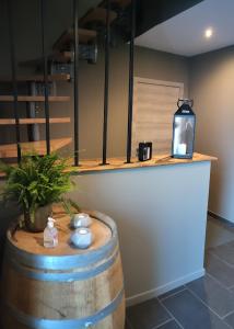 a bar in a wine tasting room with a barrel at La folie 20 Spa in Hon-Hergies