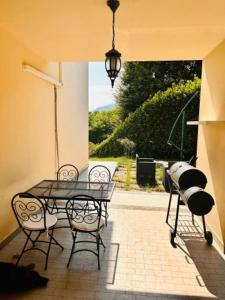 a patio with a glass table and two chairs at VILLA MONTESOLE in Lecco