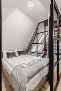 a bedroom with a large bed in a loft at Góralska Prowincja in Kościelisko