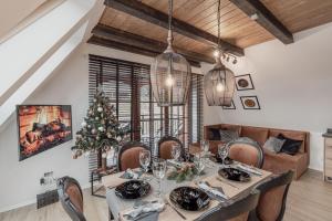 a dining room with a table and a christmas tree at Góralska Prowincja in Kościelisko +31 photos