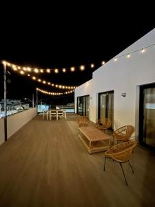 a large room with chairs and tables and lights at Arena Sunrise - Sea View and Main Street in Corralejo