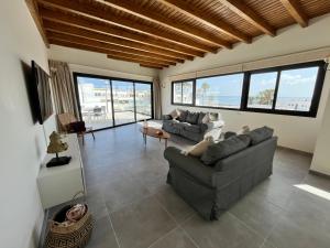 a living room with two couches and a table at Arena Sunrise - Sea View and Main Street in Corralejo