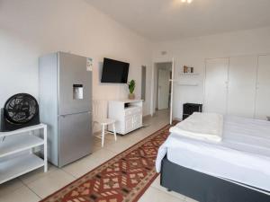 a bedroom with a bed and a tv in it at Lovely 3 Bedroom Unit Sandton in Johannesburg