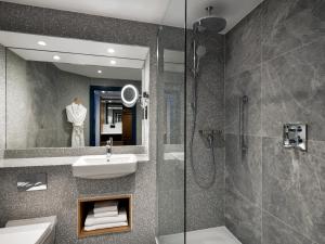 a bathroom with a sink and a shower at Edinburgh Marriott Hotel Holyrood in Edinburgh