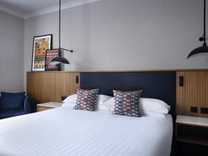 a bedroom with a large white bed with two pillows at Edinburgh Marriott Hotel Holyrood in Edinburgh