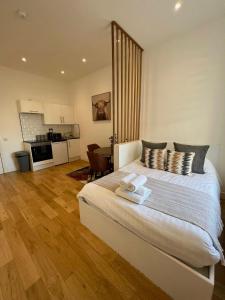 a bedroom with a large bed and a kitchen at 208, The Kové, West Hill Road in Bournemouth