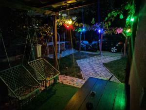 a ping pong table in a backyard at night at Party House in Tunari