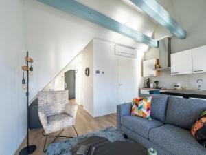 a living room with a couch and a kitchen at 2 modern apartments in the heart of Sneek in Sneek