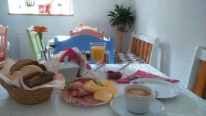 a table with a plate of food and a cup of coffee at Sandomiria in Sandomierz
