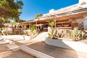 a building with potted plants in front of it at Hotel Cala Dor - Adults Only in Cala d´Or