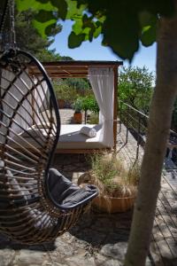 a wicker chair sitting in front of a hammock at Villa Can Rasca in Caimari