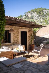 a patio with a couch and a table and chairs at Villa Can Rasca in Caimari