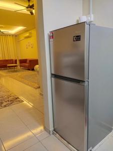 a stainless steel refrigerator in a room at Axaida Homestay Parit Jawa in Bakar Parit