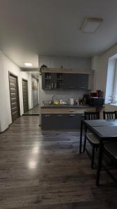 a large kitchen with a table and a counter top at Apartment in central Bucharest in Bucharest