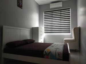 a bedroom with a bed in front of a window at Axaida Homestay Parit Jawa in Bakar Parit