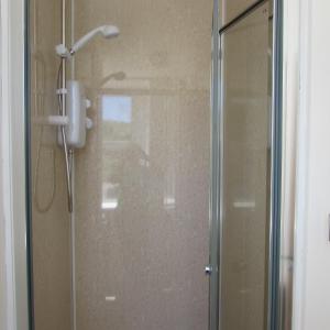 a shower with a glass door in a bathroom at Lord Nelson Hotel in Rhymney