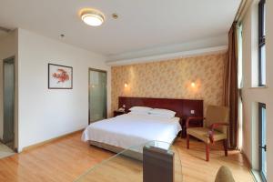 a hotel room with a bed and a desk at Milo Hotel - Near Shanghai Hongqiao National Exhibition Center in Shanghai