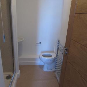 a bathroom with a white toilet in a room at Lord Nelson Hotel in Rhymney