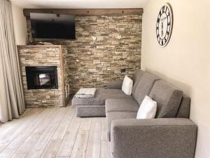 a living room with a couch and a fireplace at Casa Fochin tra Bormio e Livigno in Valdidentro +47 photos