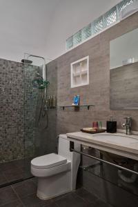 een badkamer met een douche, een toilet en een wastafel bij Eden Beach Resort by EHM in Koh Rong Sanloem