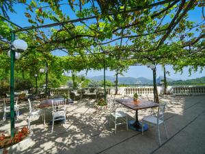 a table and chairs on a patio with a view at Hotel Scapolatiello in Cava deʼ Tirreni