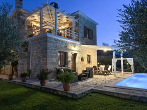 a villa with a swimming pool at night at Private Pool with Sea & Mountain View ,Full Privacy - Villa Kyriaki in Kissamos