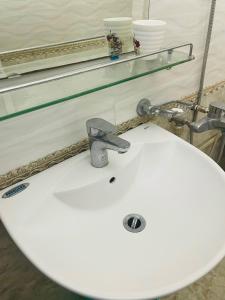 a white sink with a faucet on top of it at GM Homestay in Hai Phong