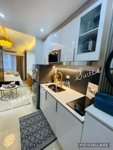 a kitchen with a sink and a counter top at Yassi's Suite at MOA in Manila