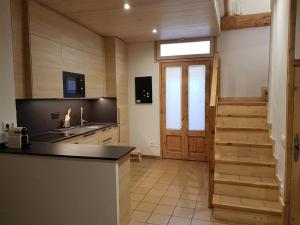 a kitchen with a wooden door and a counter top at Cal Punet-Casa Bagà in Bagá