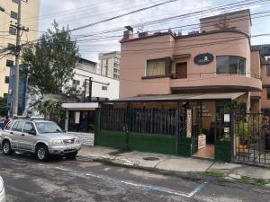 a car parked on the street in front of a building at CASA FRANCISCANA 1 in Quito
