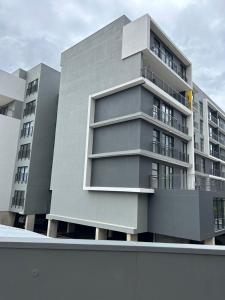 a gray building with balconies on the side of it at Apartment in Umhlanga in Umhlanga