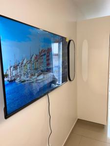 a flat screen tv hanging on a wall at Apartment in Umhlanga in Umhlanga