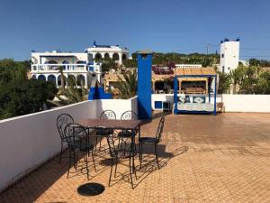 a table and chairs on the roof of a building at Room in villa Lair De La Mer no0969 in Sidi Kaouki +17 photos