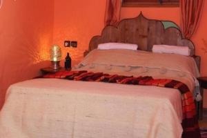 a bedroom with a large bed in an orange room at Room in villa Lair De La Mer no0969 in Sidi Kaouki