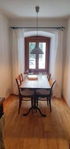 a dining room table with chairs and a window at Roccabella in Bivio