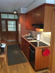 a kitchen with wooden cabinets and a sink at Roccabella in Bivio