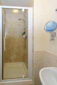 a bathroom with a shower with a tub and a sink at 2 Ogilvie Lodge in Thorpeness +27 photos