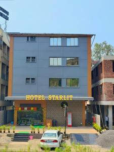 a hotel with a car parked in front of it at Hotel Starlit in Navi Mumbai