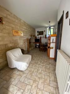 ein Wohnzimmer mit einem Bett und einer Steinmauer in der Unterkunft Casa Arianna in Ragusa