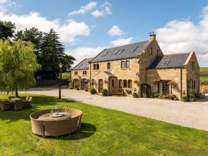 a large stone house with a large yard at Farm View Hall in Harrogate