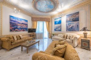 a living room filled with furniture and a ceiling at The Little Palace of Paleo Psychiko in Athens